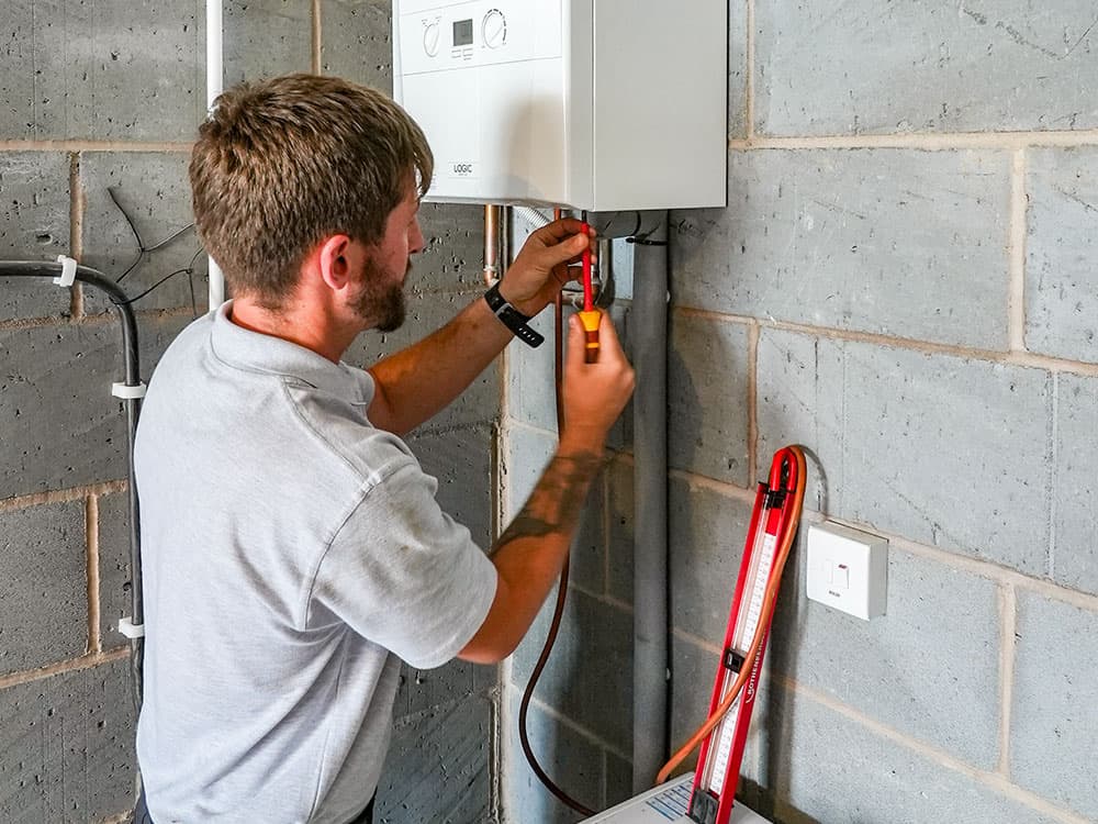 Professional heating engineer carrying out boiler repair service